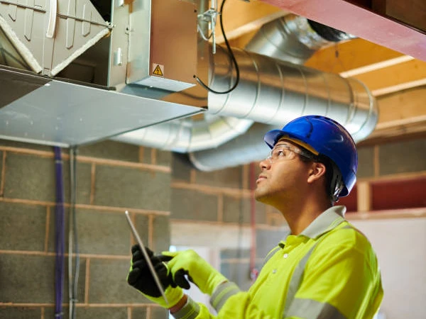 a man wearing a hard hat and gloves